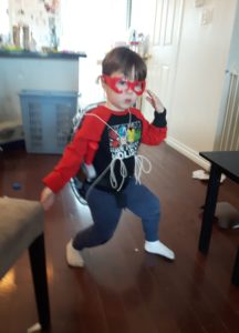 Young boy strikes a ninja pose dressed in a homemade Ninja Turtle costume